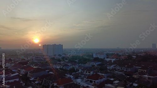 Fotografie Sunrise from surabaya cityscape, from top view at office building in surabaya