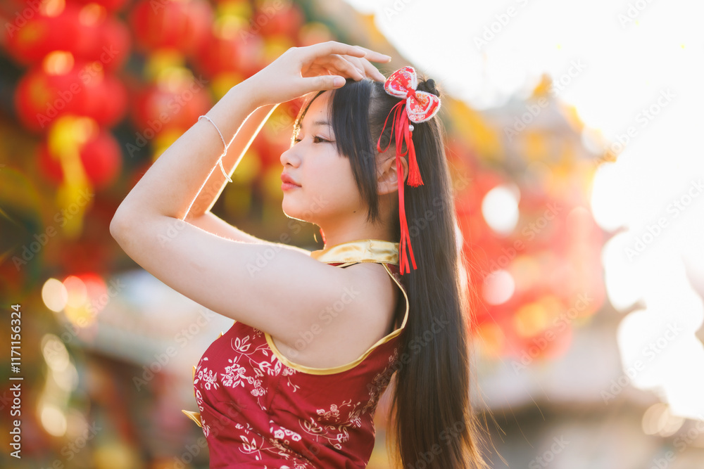Portrait beautiful cute smiles Asian young woman wearing red cheongsam dress traditional decoration for Chinese new year festival celebrate culture of china at Chinese shrine Public places in Thailand