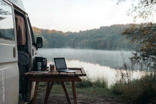 Digital nomad working remotely from camper van by serene mountain lake