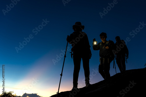 Photography Silhouette trekker man holding camping lamp during hiking at night