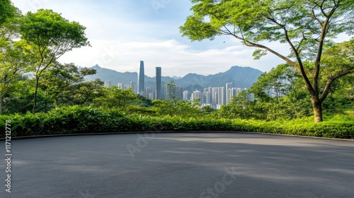 Fototapeta Naklejka Na Ścianę i Meble -  A stunning view of a modern city skyline featuring impressive skyscrapers and a deserted asphalt road beneath a clear blue sky