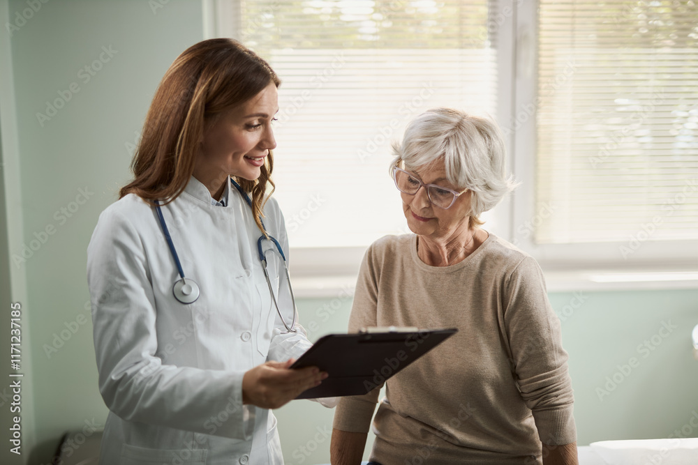 Fototapeta premium Female doctor and his senior patient examining documents during an appointment in hospital.