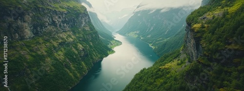 A breathtaking aerial perspective of the Norwegian fjords in Geiranger, Norway, with steep cliffs and emerald-green waters under the soft light of a summer morning photo