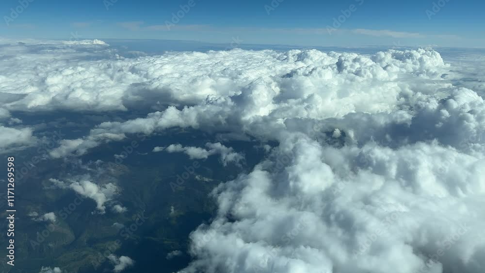 Flying over cumulonimbus clouds in summer Flying over cumulonimbus clouds in summer