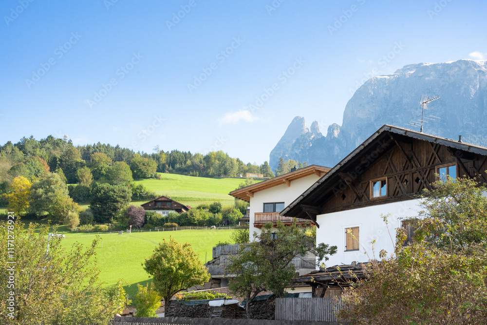 View of the Italian Alps Dolomites with traditional town architecture in view. 