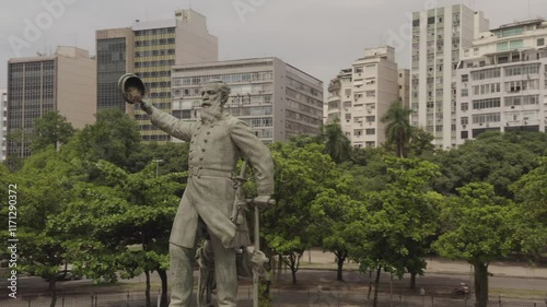 Flying around Admiral Barroso Monument at Paris Square with urban buildings in background, aerial view of Gloria district in Rio de Janeiro, Brazil