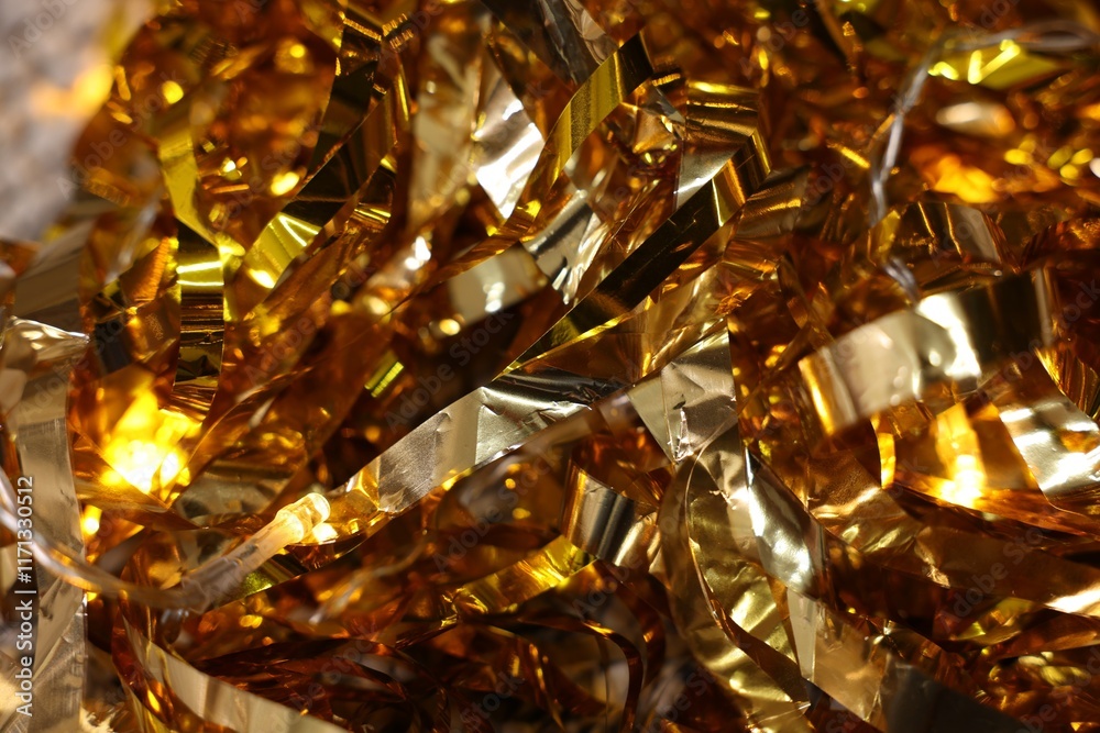 Shiny golden tinsel as background, closeup view Shiny golden tinsel as background, closeup view
