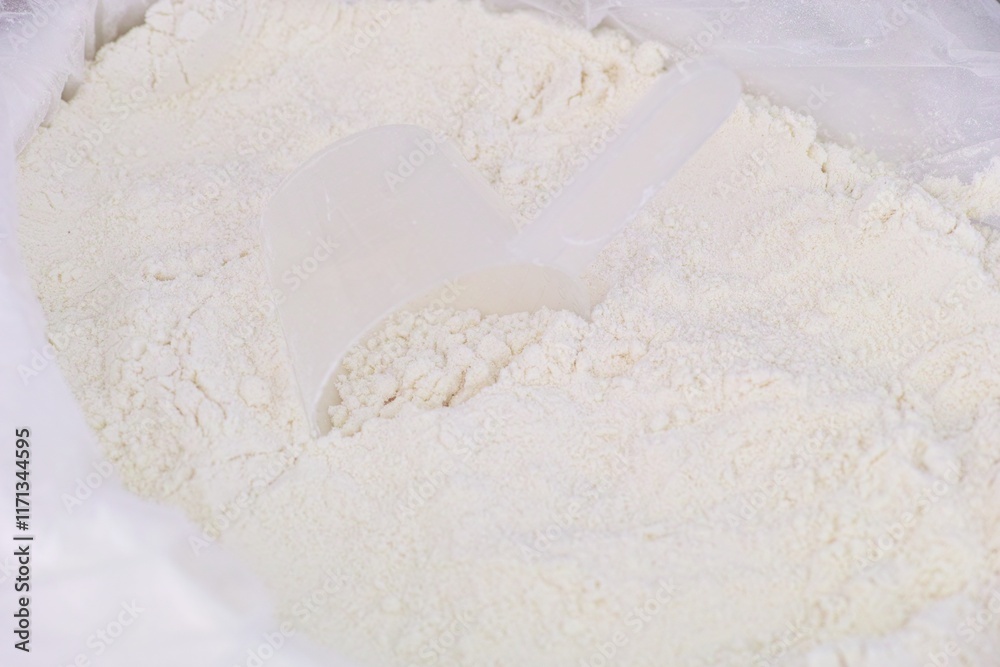 Close-up shot of a measuring spoon in a pack with flour. Close-up shot of a measuring spoon in a pack with flour.