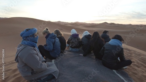 Africa, Morocco, Merzouga 5,1,2025 
tourists visit and take an adventurous trip to the Sahara desert with a Berber guide they go to the sand dunes desert riding camels , looking sunrise morning time  photo