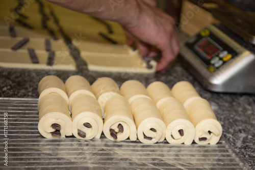 ready to bake croissant chocolate on cutting board with puff pastry photo