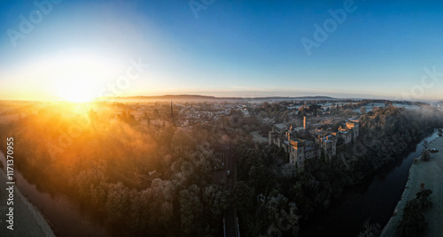 Aerial view of Lismore Castle in County Waterford, Ireland, on a frosty winter morning, showcasing its stunning Gothic Revival architecture against a cold, atmospheric landscape photo