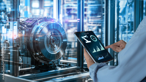 Smart industry automation manufacturing control concept.Hands holding tablet on blurred automation machine as background..