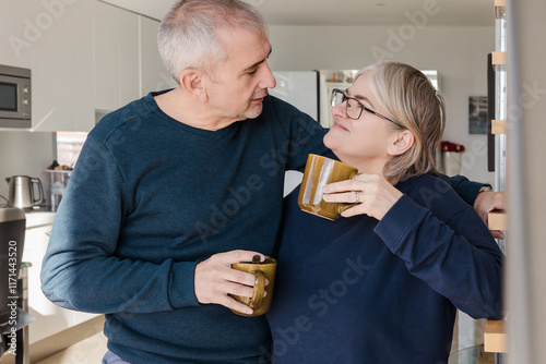 Senior couple enjoying coffee and each other's company at home photo