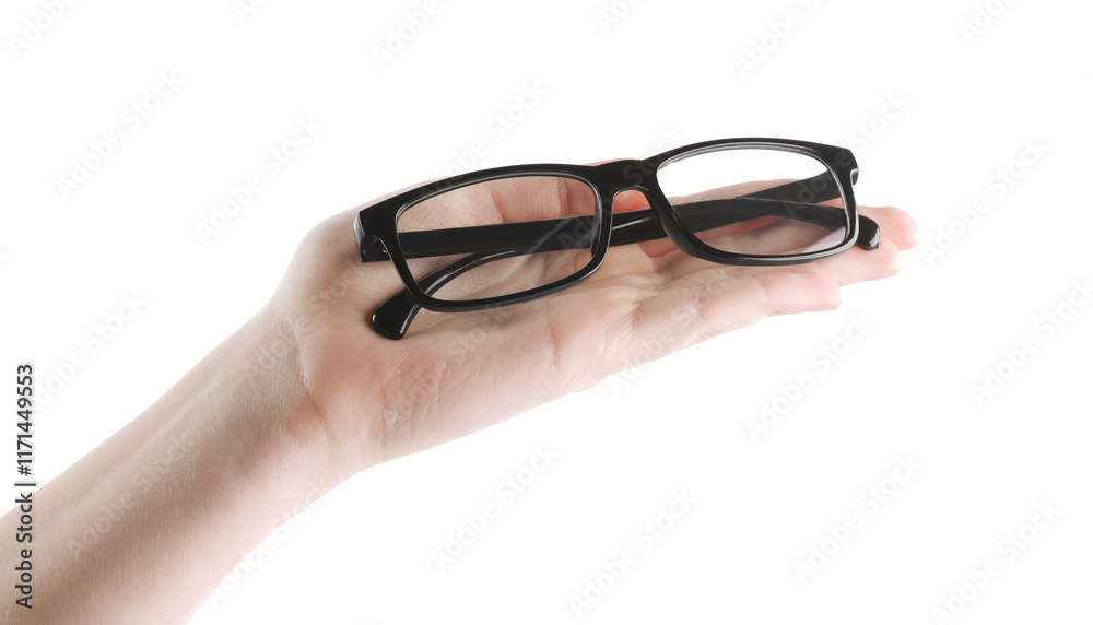 Woman holding glasses with black plastic frame on white background, closeup Woman holding glasses with black plastic frame on white background, closeup