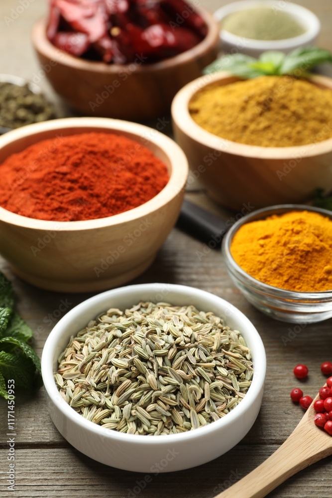 Different aromatic spices on wooden table, closeup Different aromatic spices on wooden table, closeup