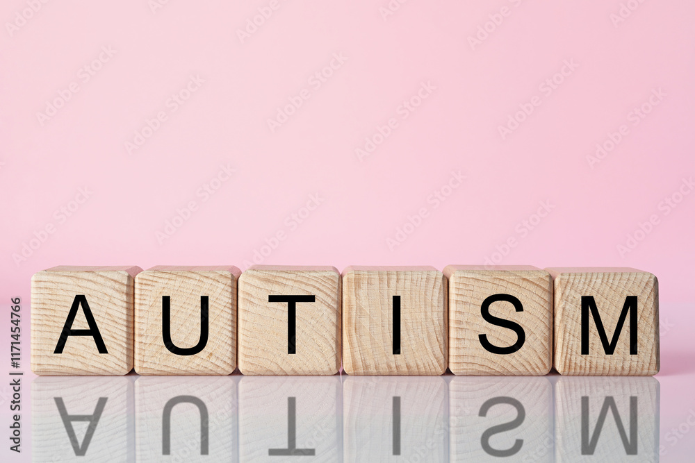 Word Autism made of wooden cubes against pink background, space for text Word Autism made of wooden cubes against pink background, space for text