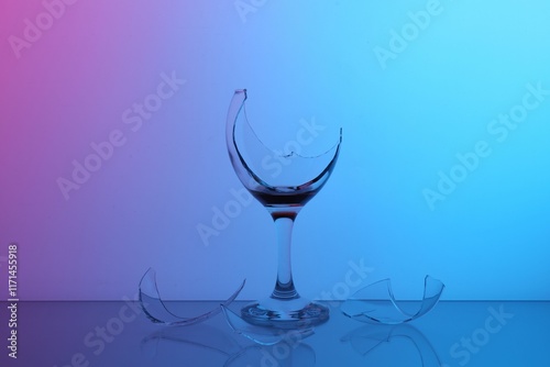 Принти на полотні Pieces of broken glass with wine on table, color tone effect
