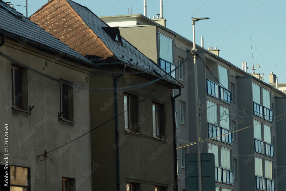 Facade of a residential building with windows, showcasing modern urban design. The architecture reflects functionality and aesthetics, blending seamlessly into the urban landscape. Facade of a residential building with windows, showcasing modern urban design. The architecture reflects functionality and aesthetics, blending seamlessly into the urban landscape.