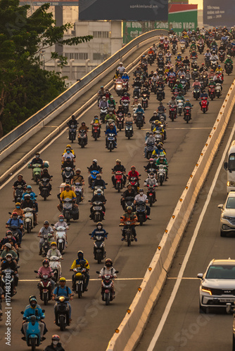 Heavy traffic during rush hour and colorful scene on Saigon streets, crowded with people and motorbikes