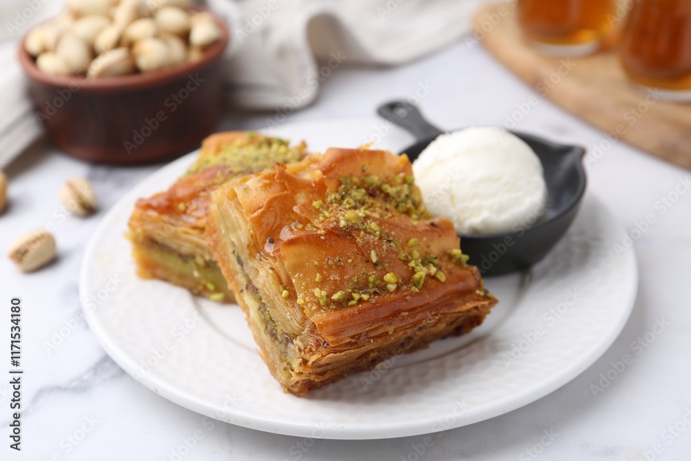 Delicious baklava with crushed nuts and ice cream on white marble table, closeup Delicious baklava with crushed nuts and ice cream on white marble table, closeup