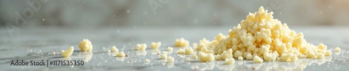 White chocolate shavings with sparkling silver chocolate splash on glass surface, modern, glitzy