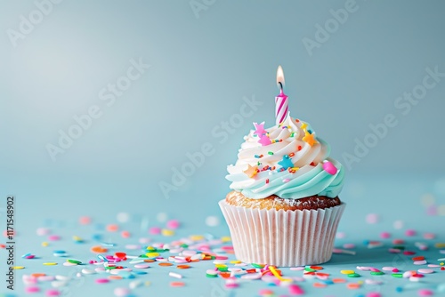 Festive cupcake with candle and sprinkles