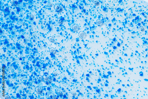 Texture of face scrub with blue micro-exfoliating particles