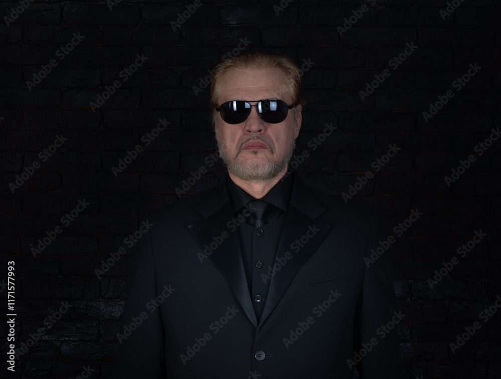 Fototapeta premium close-up portrait of an old man in a black classic suit