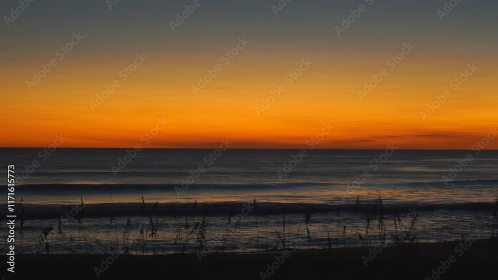Breathtaking beautiful sunrise sky with vibrant colors sun rising over the Atlantic Ocean Breathtaking beautiful sunrise sky with vibrant colors sun rising over the Atlantic Ocean