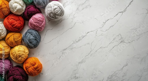 Colorful yarn balls arranged on a marble surface for creative textile projects