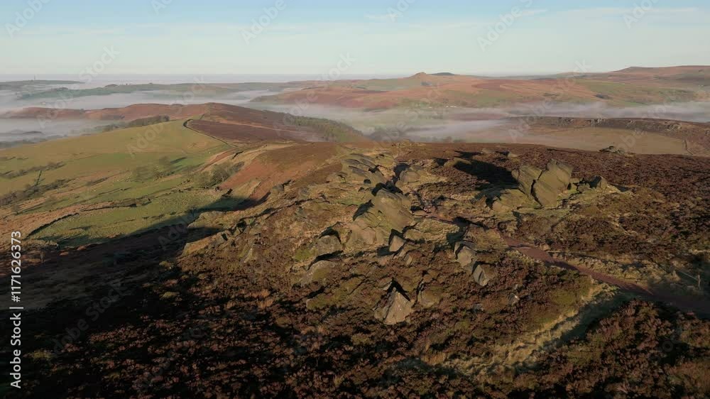 Aerial drone shot of a trail runner at The Roaches in the Peak District National Park, England, UK.