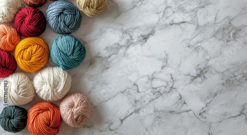 Colorful yarn balls arranged on a marble surface for creative textile projects