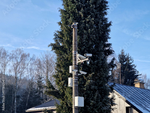 camera system monitoring the speed of traffic vehicles on the city motorway ring. the fine comes by mail to anyone who exceeds the speed limit. two cameras in two directions photo