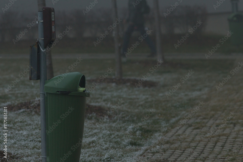 Urban Trash Bin on a Frosty, Foggy Winter Day. Cold atmosphere and muted tones emphasize the quiet stillness of the season Urban Trash Bin on a Frosty, Foggy Winter Day. Cold atmosphere and muted tones emphasize the quiet stillness of the season