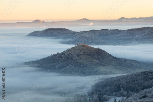 Blick vom Breitenstein, Ochsenwang, Schwäbische Alb auf die drei Kaiserberge - Hohenstaufen, Stuifen und Rechberg. Im Vordergrund die Limburg bei Weilheim Teck im Winter zum Sonnenaufgang mit Nebel. photo