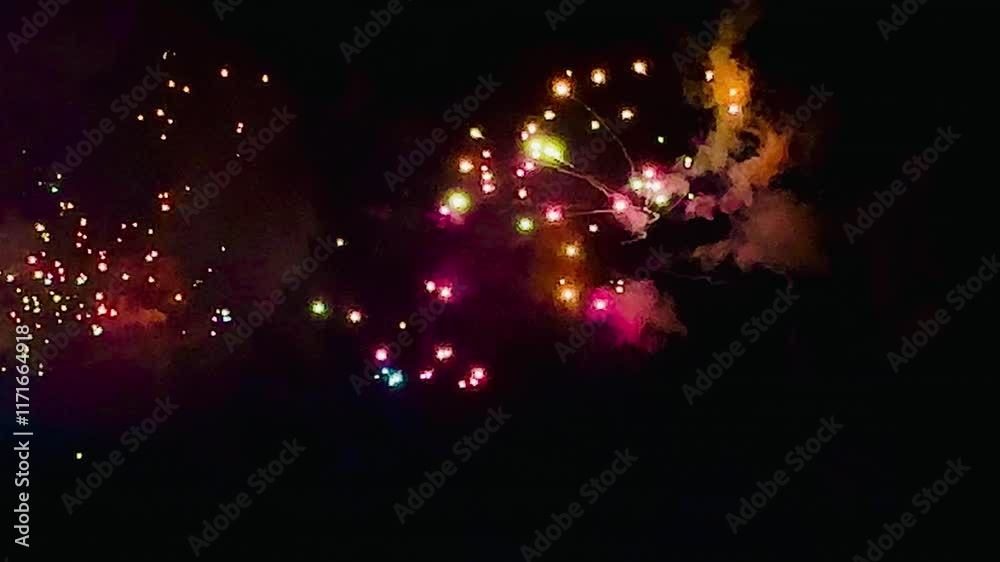 4K. loop seamless of real fireworks background golden shining fireworks with bokeh lights in the night sky. glowing fireworks show. New year's eve fireworks celebration multiple colors in bangkok