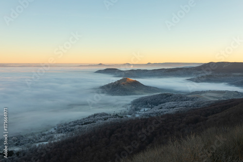 Blick vom Breitenstein, Ochsenwang, Schwäbische Alb auf die drei Kaiserberge - Hohenstaufen, Stuifen und Rechberg. Im Vordergrund die Limburg bei Weilheim Teck im Winter zum Sonnenaufgang mit Nebel. photo