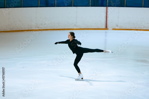Girl figure skater trains on skates on the ice.