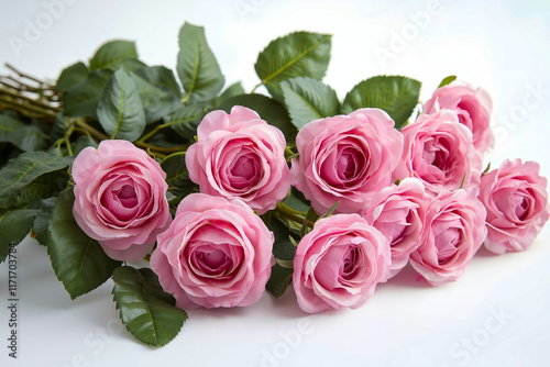 A bunch of pink roses on a white surface