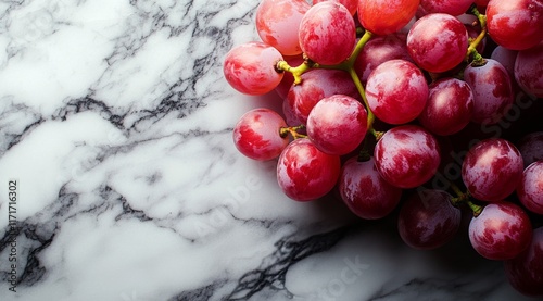 Fresh red grapes arranged on a marble surface ready for snacking or culinary use