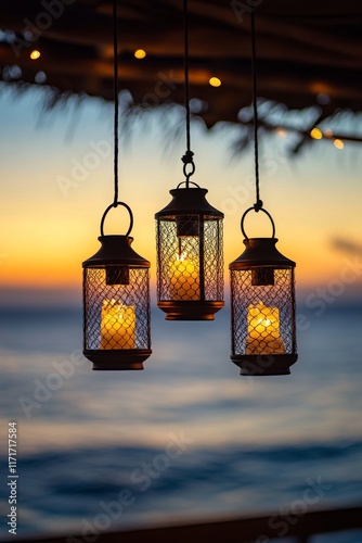 Beautiful lanterns with candles hang above the ocean during sunset in a tranq...
