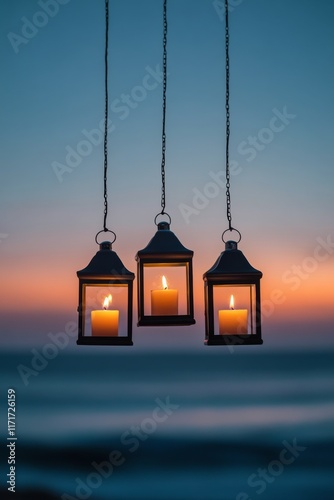 Beautiful lanterns with candles hang above the ocean during sunset in a tranq...