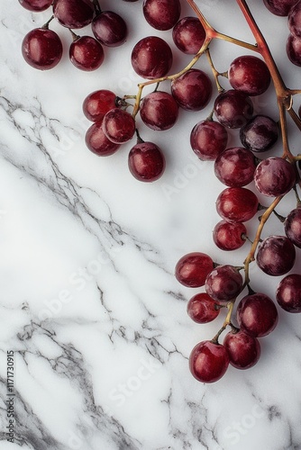 Fresh red grapes on a marble surface showcasing their vibrant color and smoot...