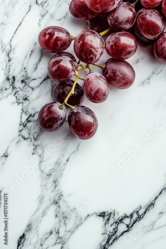Fresh red grapes on a marble surface showcasing their vibrant color and smoot...