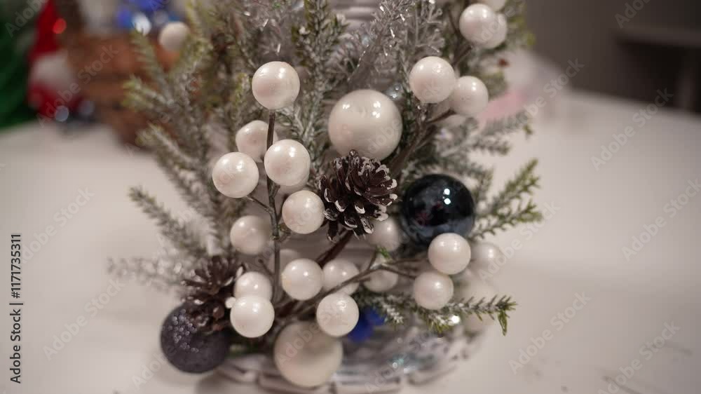 A festive arrangement combines white ornaments, pinecones, and natural foliage to create a beautiful holiday centerpiece. Perfect for celebrating and enhancing holiday decor. A festive arrangement combines white ornaments, pinecones, and natural foliage to create a beautiful holiday centerpiece. Perfect for celebrating and enhancing holiday decor.