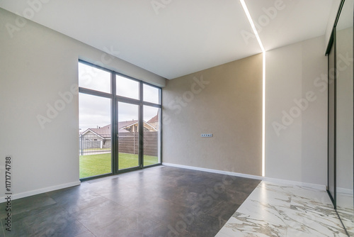 Wallpaper Mural The room is unfurnished, with a panoramic window. Tile floor. Courtyard with a green .lawn outside the window of a country house. Torontodigital.ca