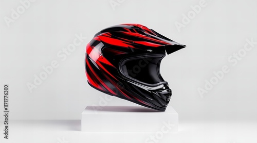 Sleek red and black motocross helmet on a minimalist white display.  Safety gear for extreme sports. photo