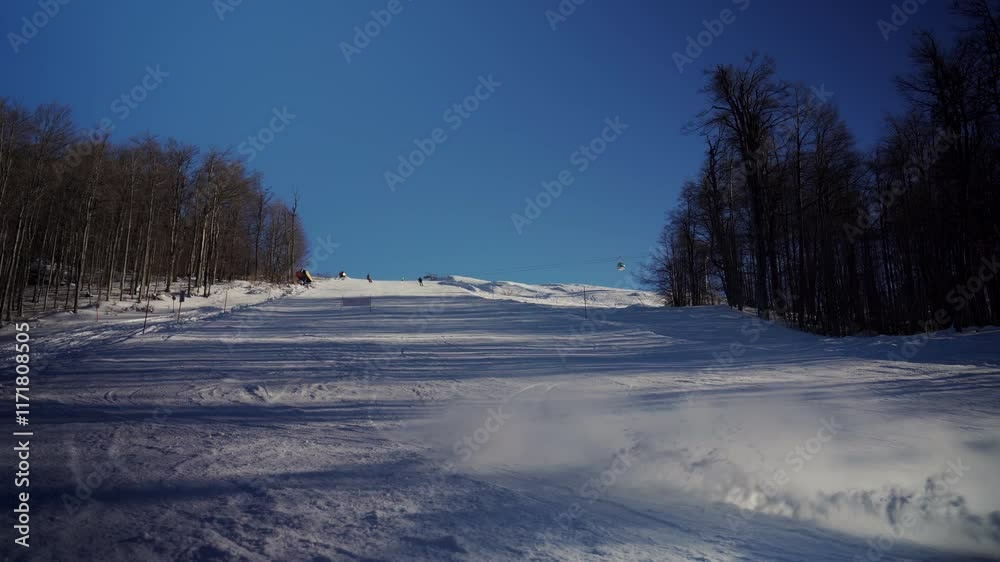 Snowy Mountain Scene with Athlete Skiing Under Clear Blue Sky Snowy Mountain Scene with Athlete Skiing Under Clear Blue Sky