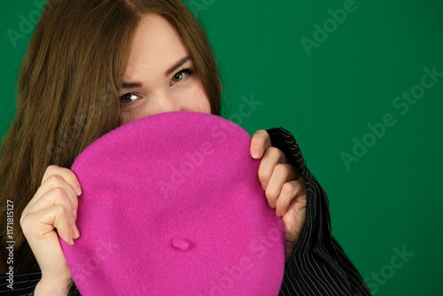 Beautiful you woman in pink dress and pink beret smiling happily. High quality photo photo