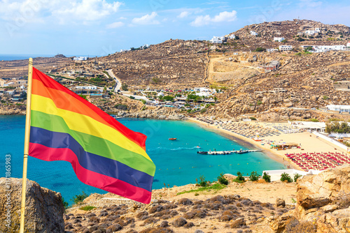 Fototapeta Naklejka Na Ścianę i Meble -  Super paradise beach on Mykonos island, Greece with Rainbow flag LGBT movement symbol
